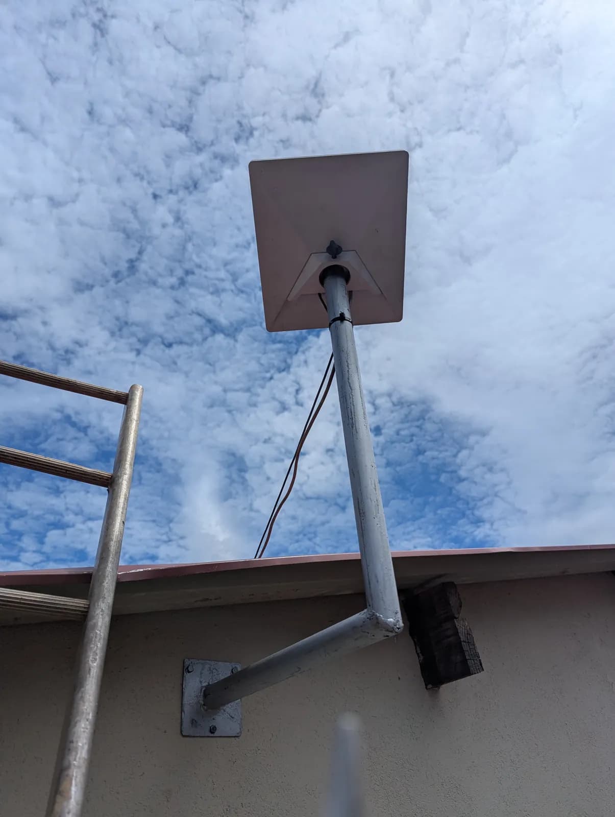 Starlink dish on a pole mount on a flat roof in Zimbabwe