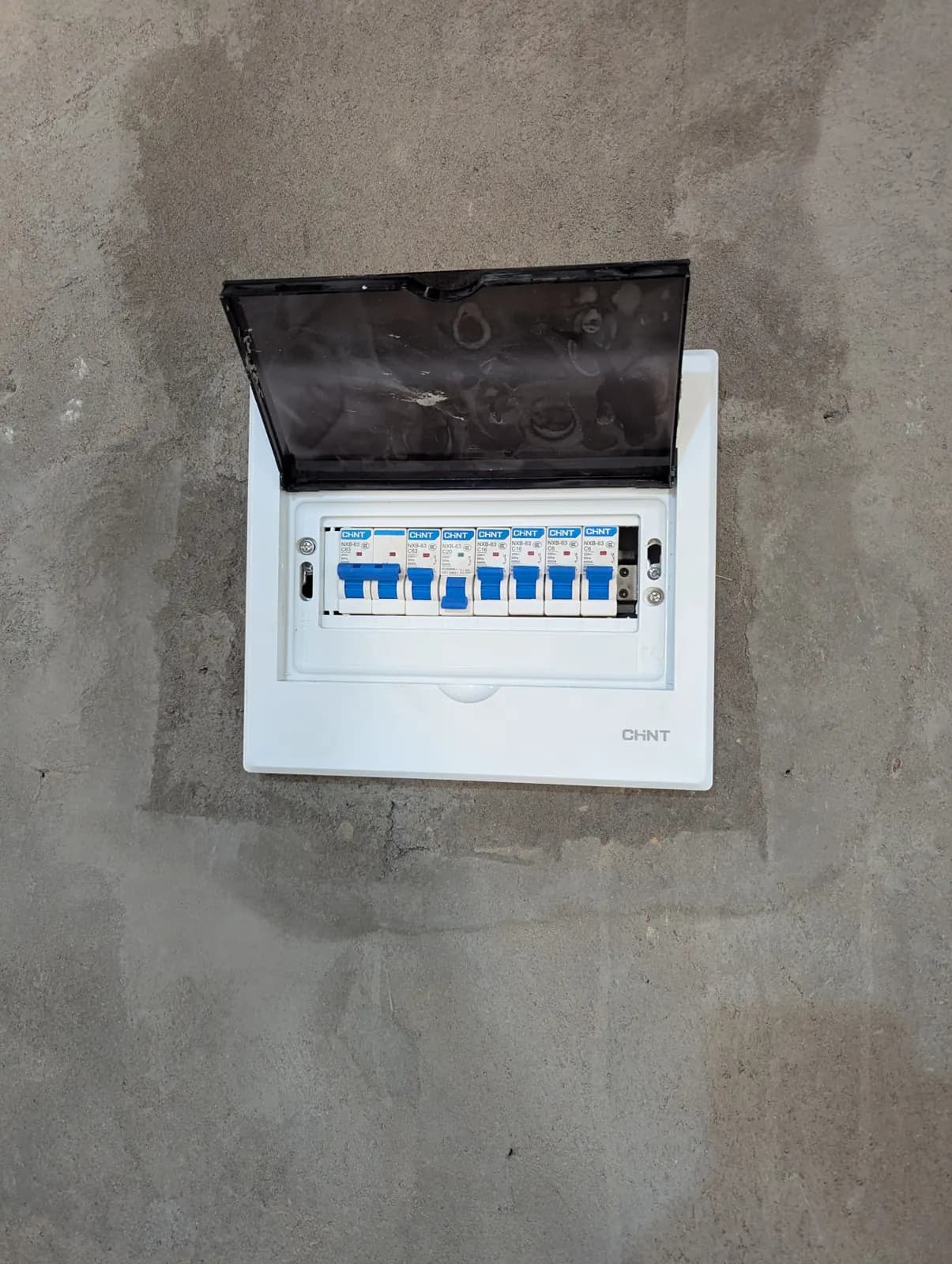 Tubing & Wiring: A new distribution board set into the wall, breakers labelled and ready for the circuits in Goromonzi, Zimbabwe